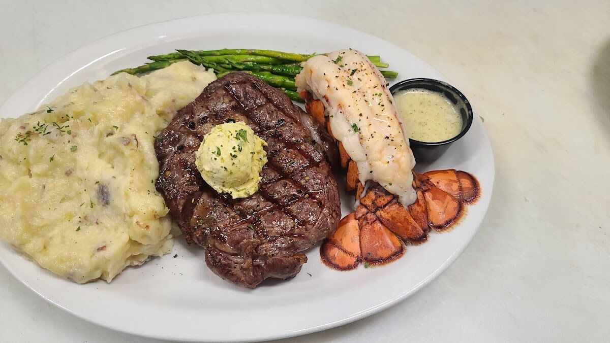 Steak and lobster at Just Chill Pub & Grill: a grilled steak with herb butter, a lobster tail, garlic mashed potatoes, asparagus and drawn butter.